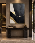 NOCTARA black ivory beige and gold abstract wall art above a black stone console in a refined entryway